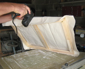 stappling canvas on the frame
